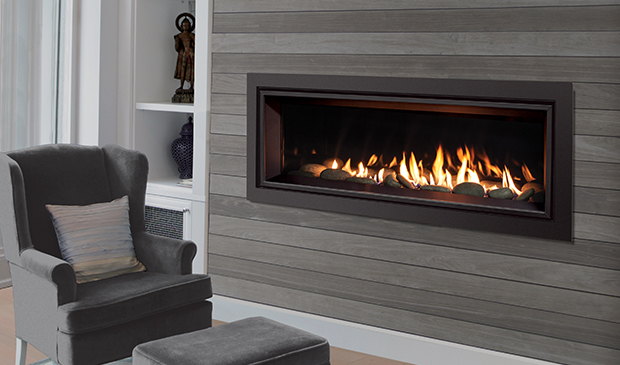 Enviro C44 burning in a grey plank wall beside a wing chair