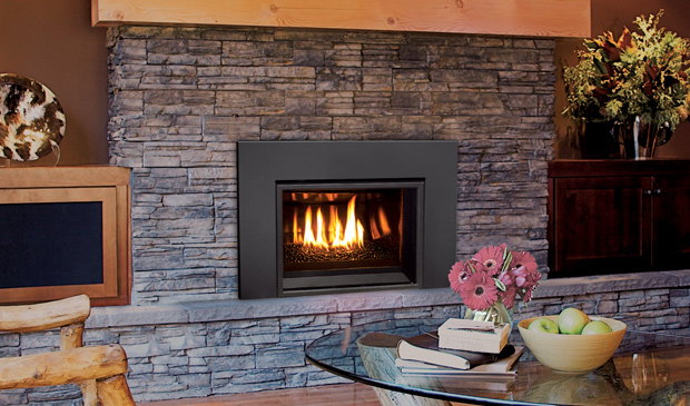 Enviro E20 gas insert set in a grey stone fireplace in a cottage living room