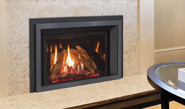 Enviro EX32 gas insert with red ember media beside a glass table