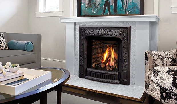 Enviro Q1 insert in a white parlour fireplace beside a round table