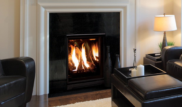 Enviro Q1 gas fireplace in a black surround beside a leather chair