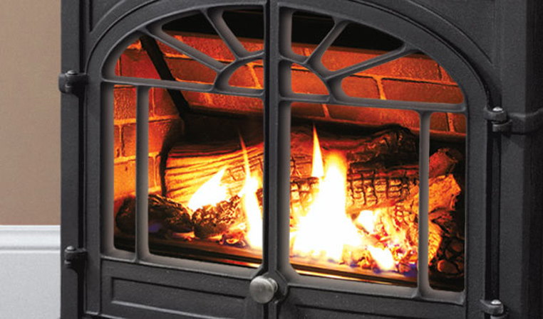 Log fire through the arched glass of the Enviro Westport cast iron stove