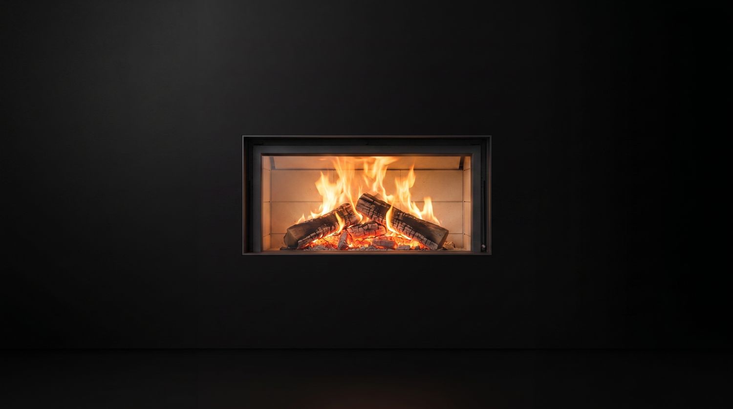 A Stûv 21 wood fireplace burning, photographed on black