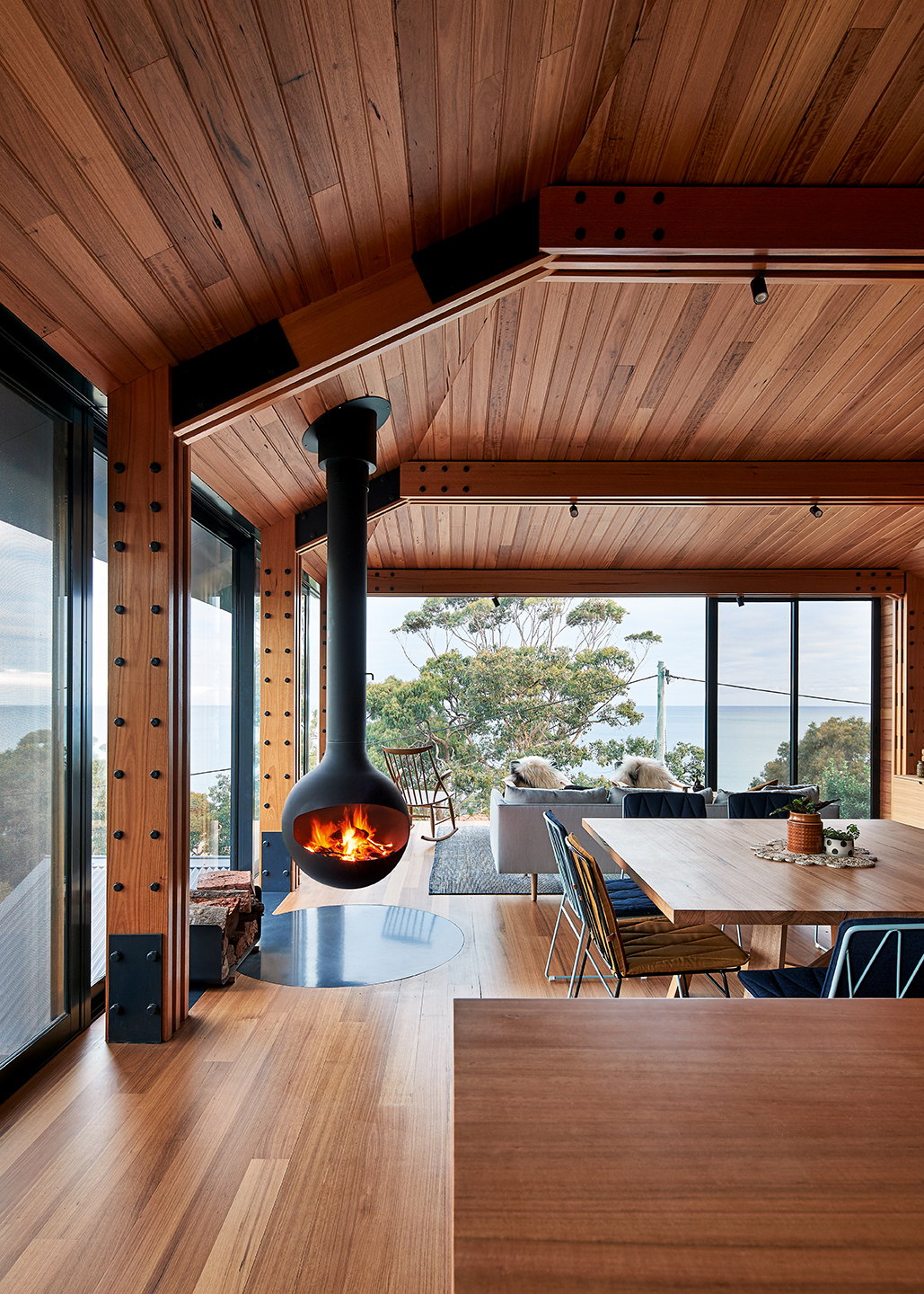 Black Bathyscafocus sphere burning in a cedar-lined chalet living room above the water