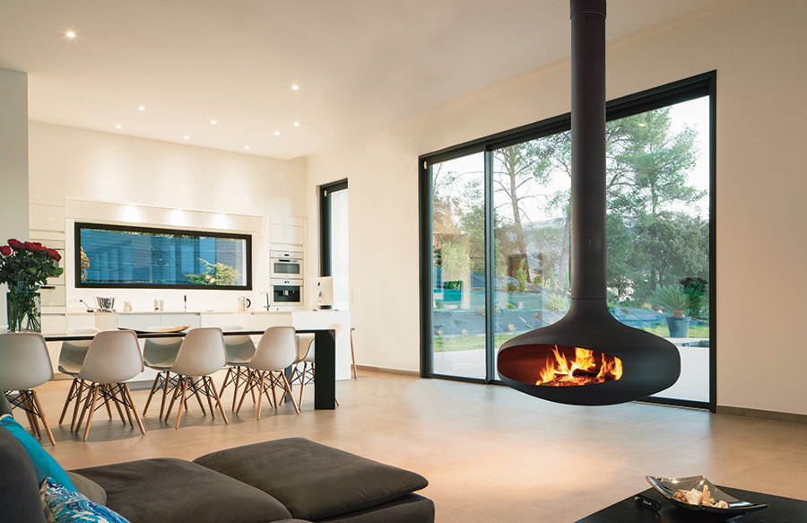 Black Domofocus at the edge of an open kitchen and dining room, fire lit