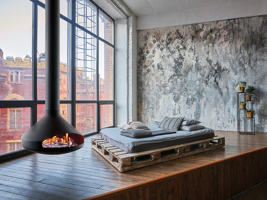 Ergofocus Gas burning beside a pallet bed in a concrete-walled studio loft