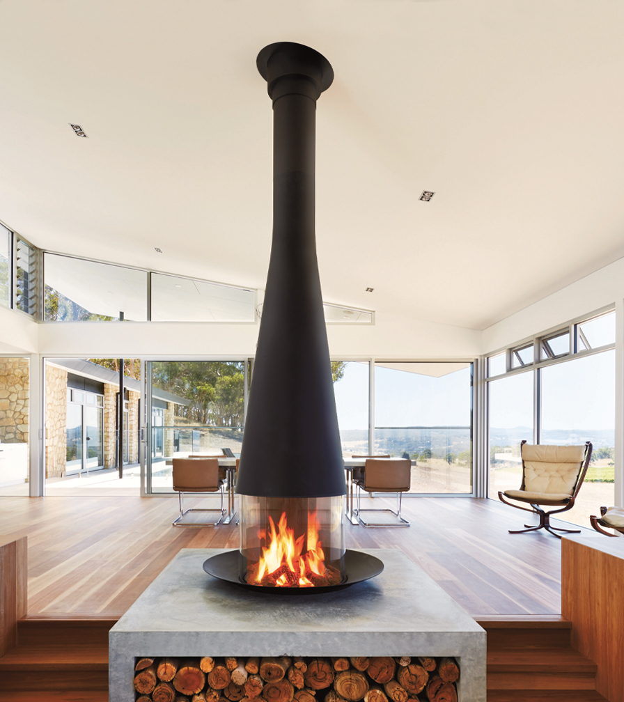 Filiofocus Central burning in a glass hilltop room, logs stacked in its plinth
