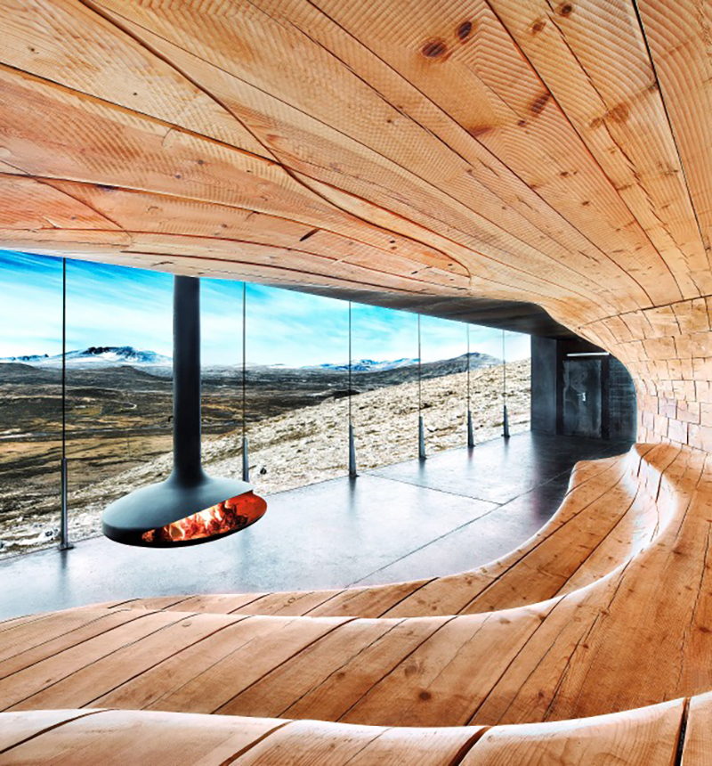 Gyrofocus hanging before a panoramic window in a curved timber pavilion overlooking open tundra