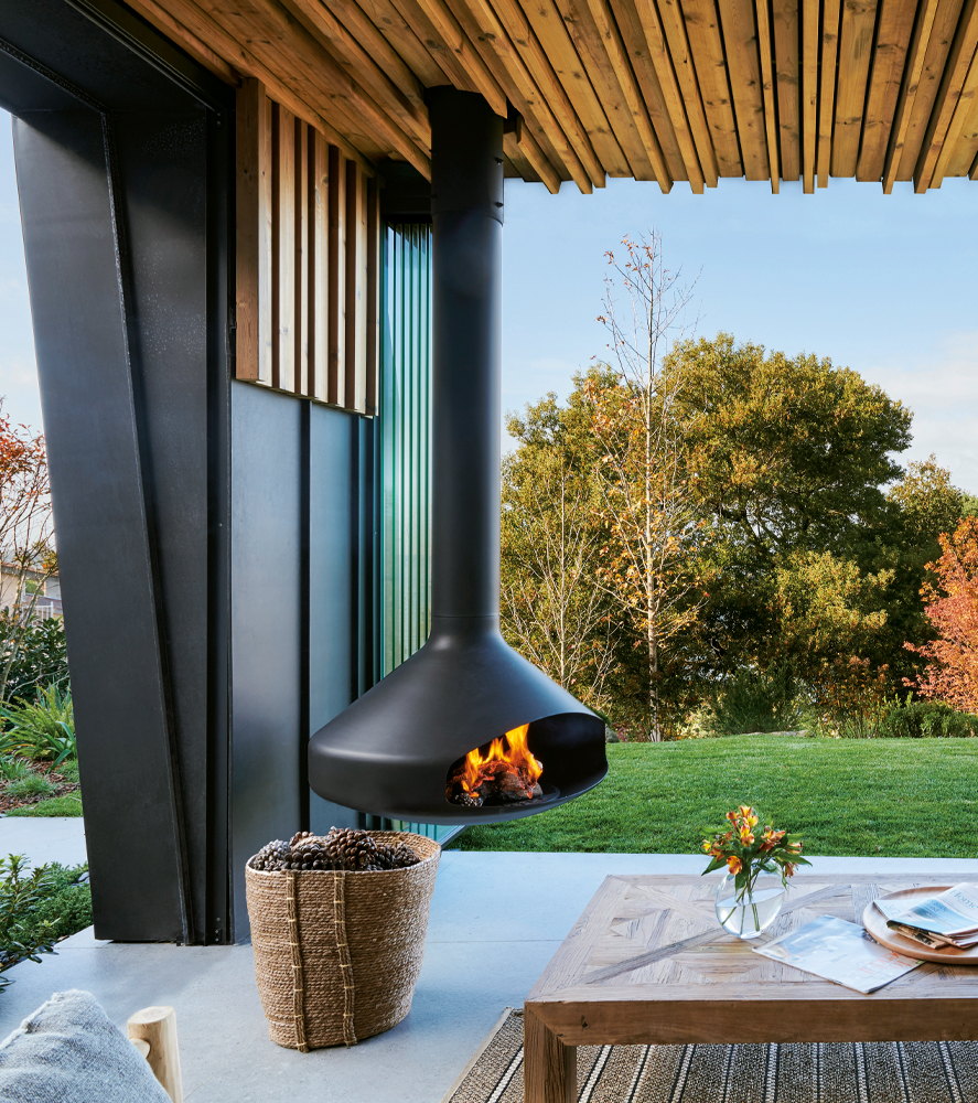 Paxfocus hanging on a covered porch with a lawn and trees beyond