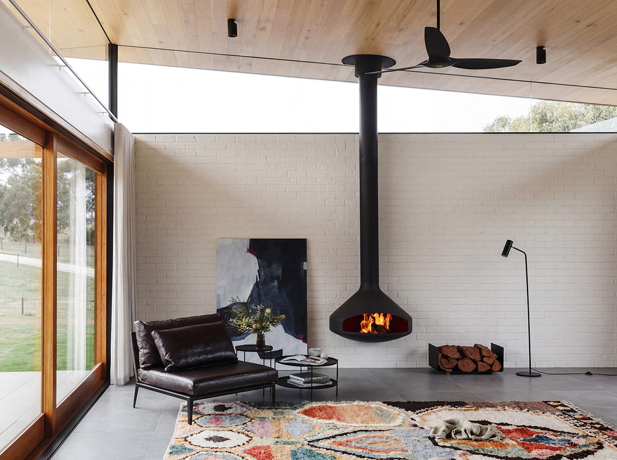 Paxfocus alight in a white-brick living room with a patterned rug