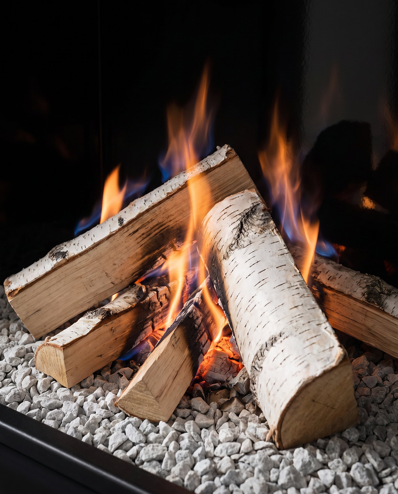 The U33’s birch split logs and glowing embers over the pale stone bed, up close