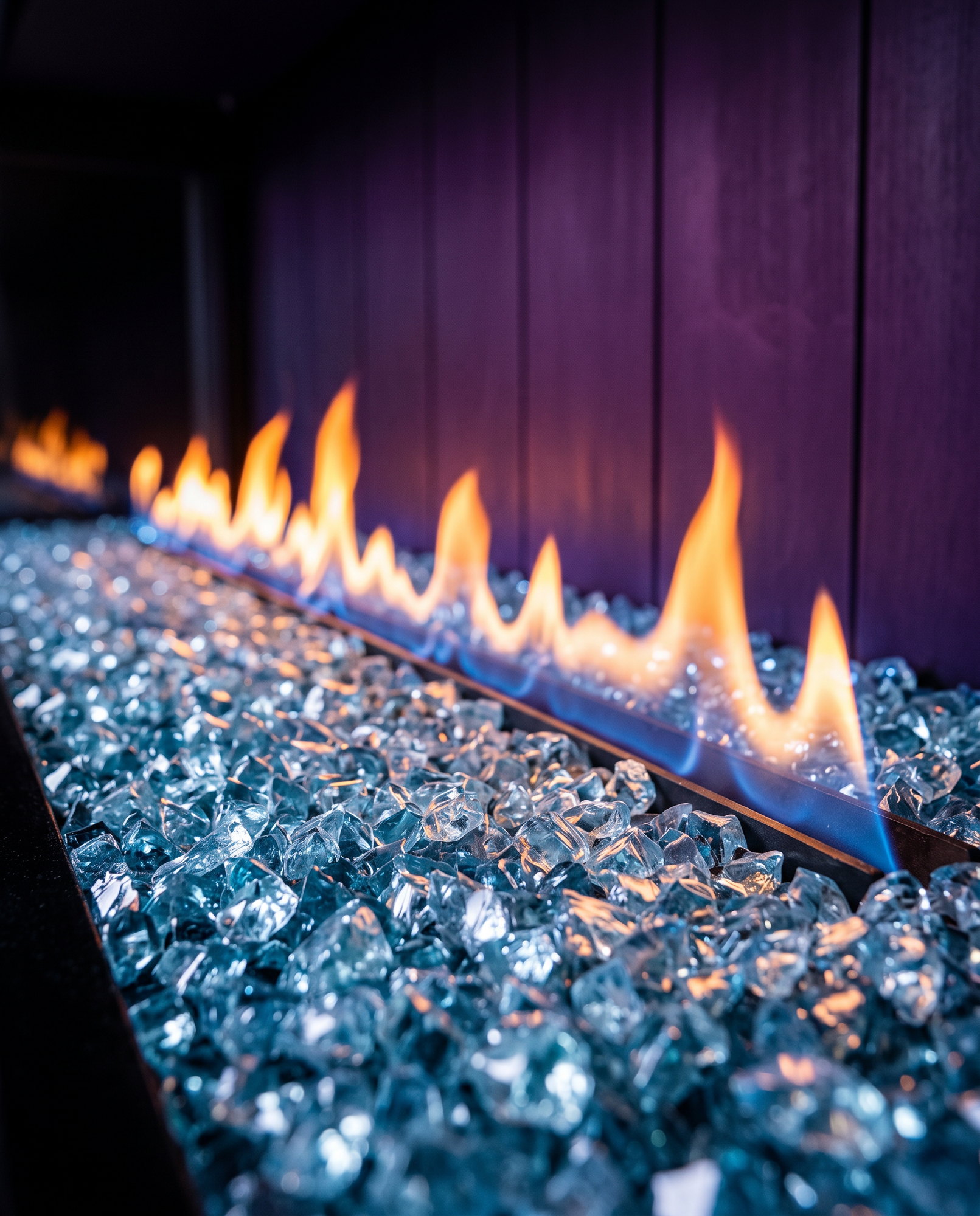 The U70 Bay&rsquo;s crushed-glass ember bed up close, ribbon flame rising from it