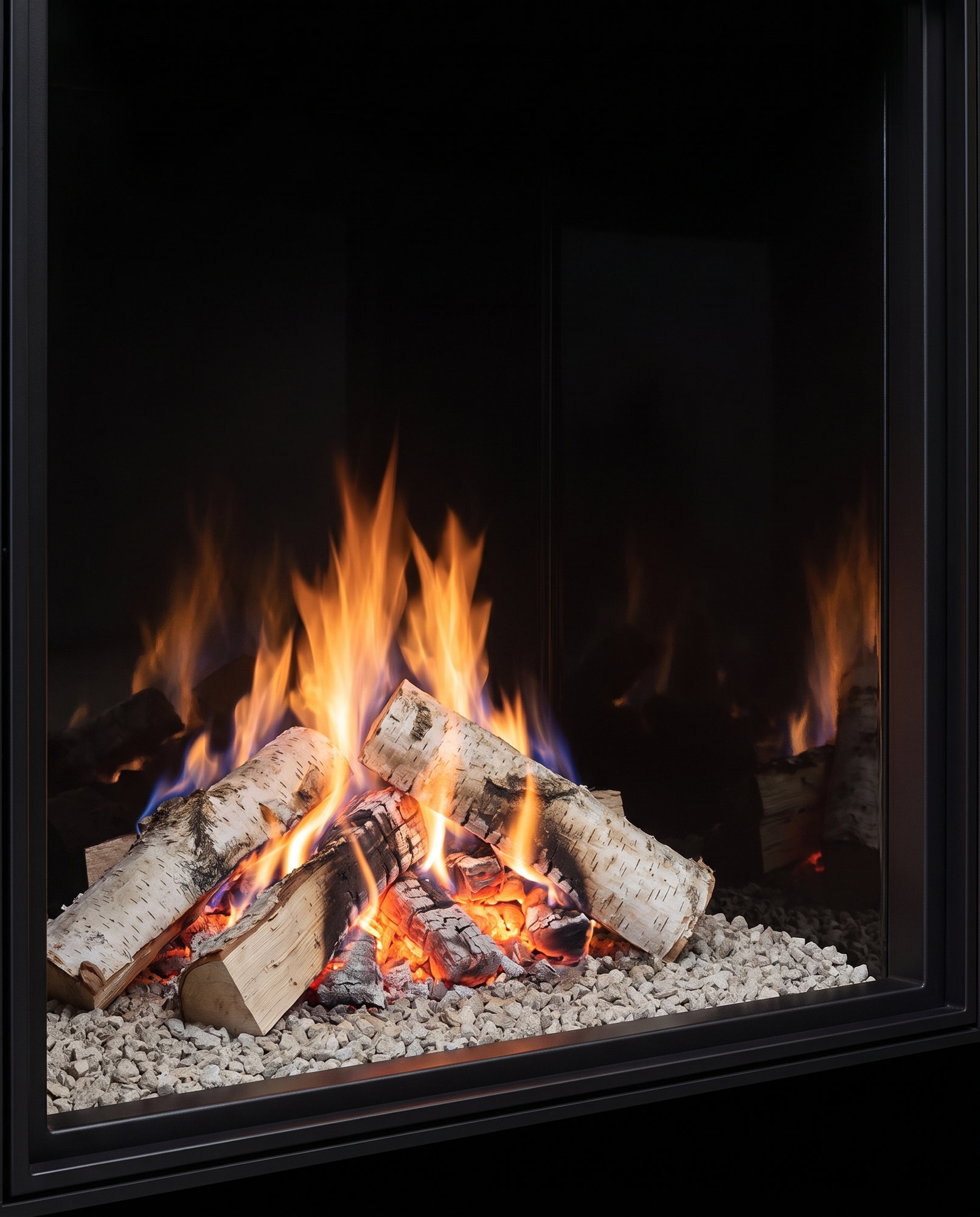 The U33’s birch fire through the front glass, straight on — clean face at both edges