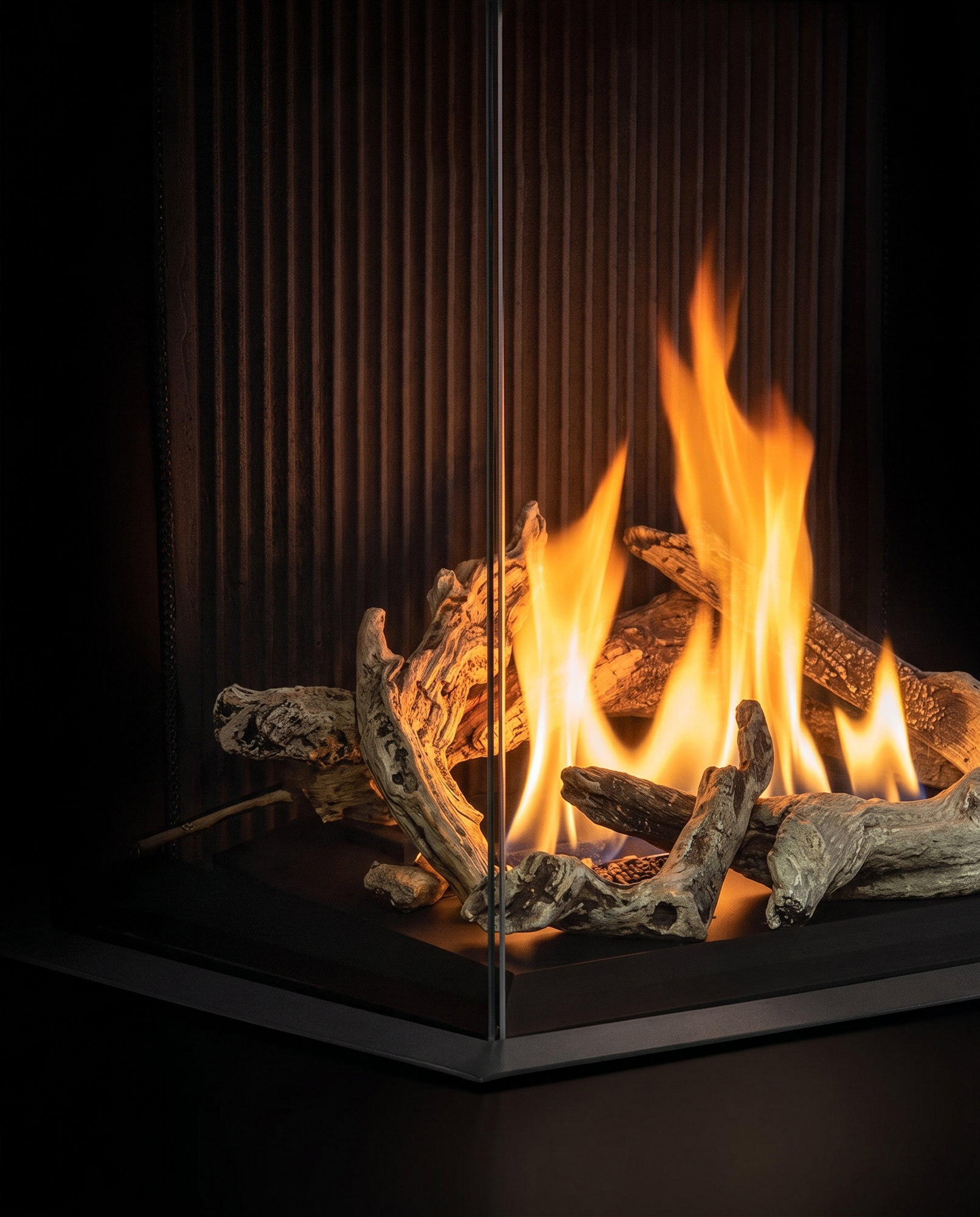 The glass-to-glass corner of the U30 Bay, driftwood fire against the fluted liner