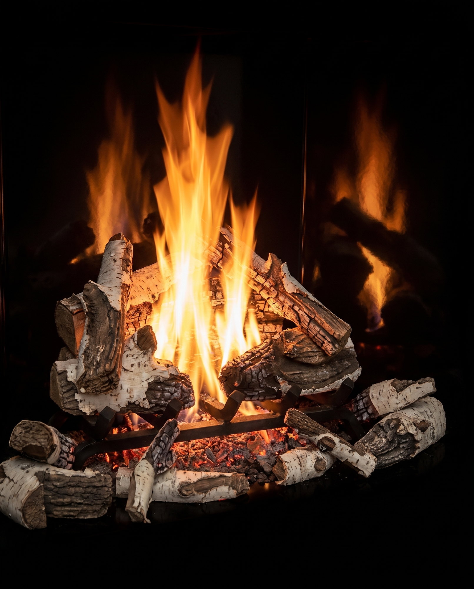 The U55’s birch logs on their grate, embers glowing, fire reflected behind