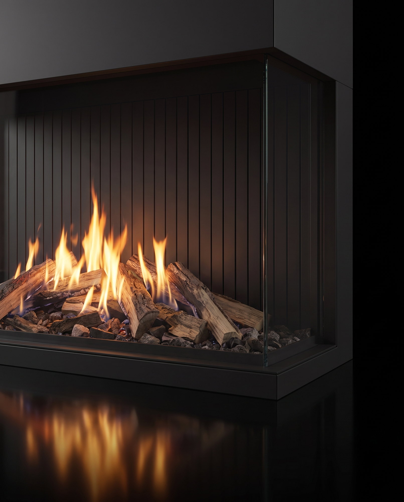 The U70 Tall Ultra’s glass-to-glass corner, the split-log fire reflected in the black floor