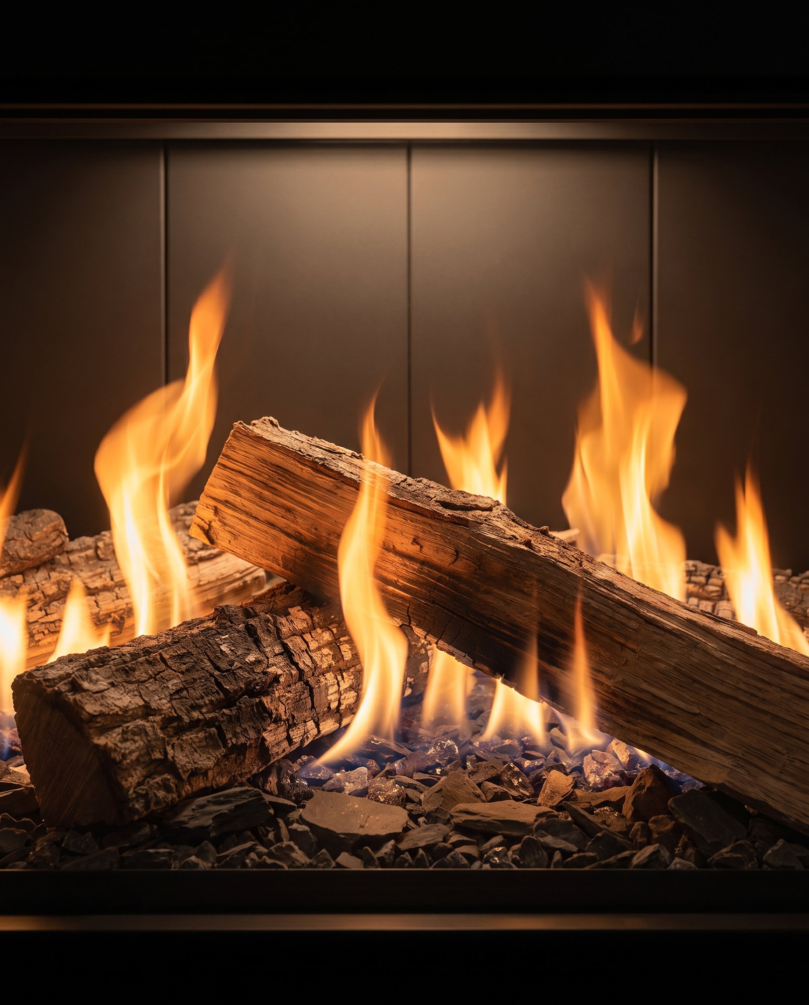 Inside the U70 Tall Linear &mdash; split hardwood logs and flame on the shale bed, up close