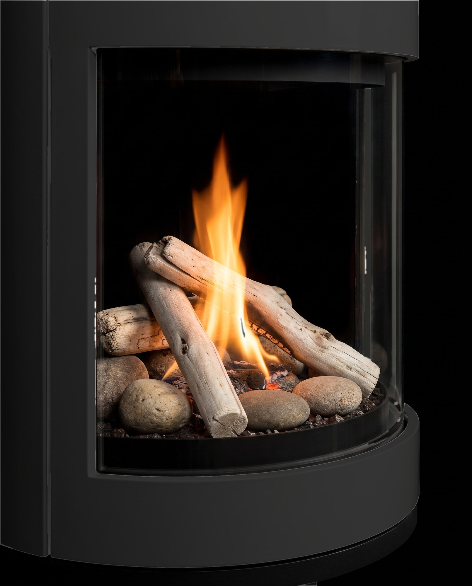 Through the S50&rsquo;s curved glass &mdash; river rocks and twig-wood over the burner