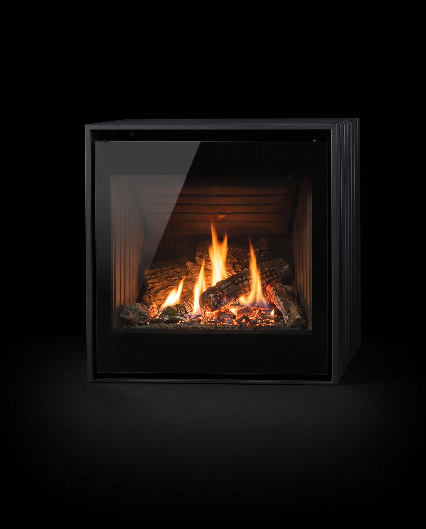 The Cube’s square glass dead-on — high-definition logs burning, fluted panels at both edges