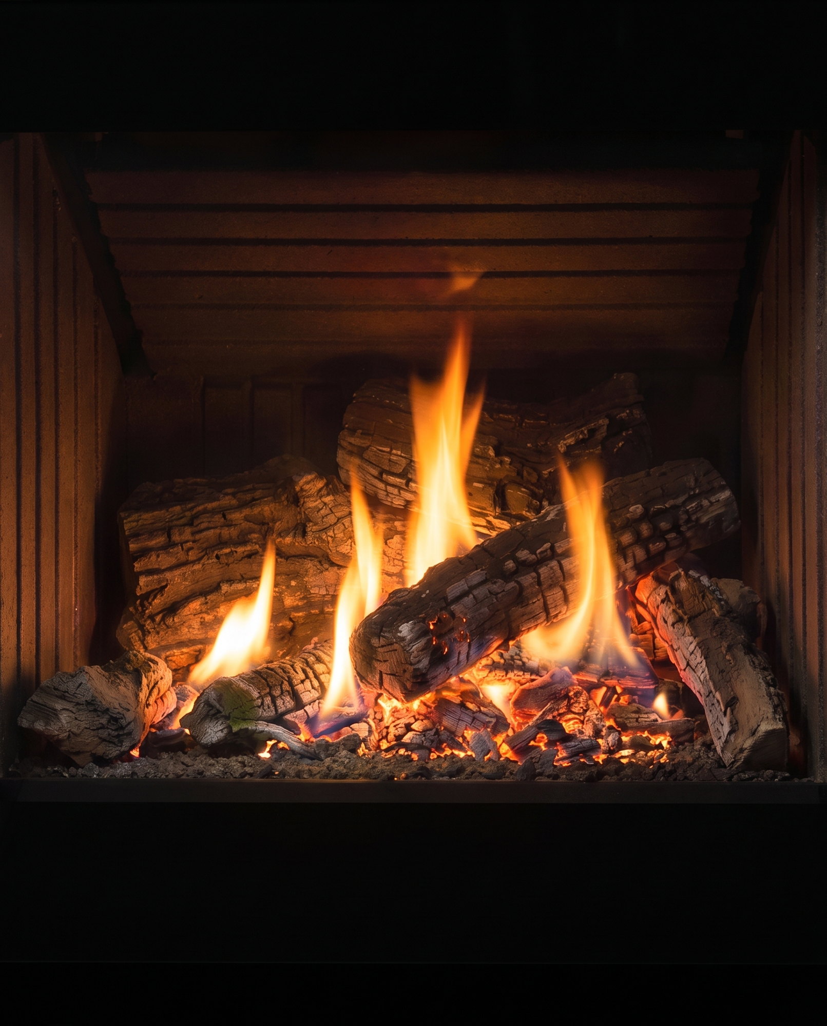 Inside the Cube’s firebox — logs over embers against the maker’s slatted interior