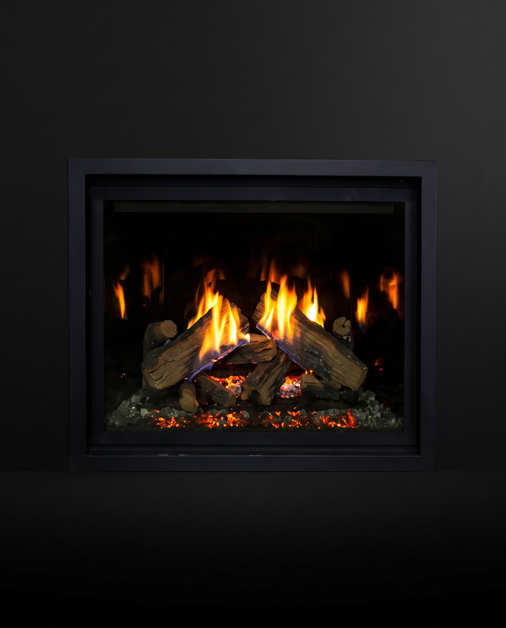 The RZ41’s full face dead-on — flames rising between the split logs