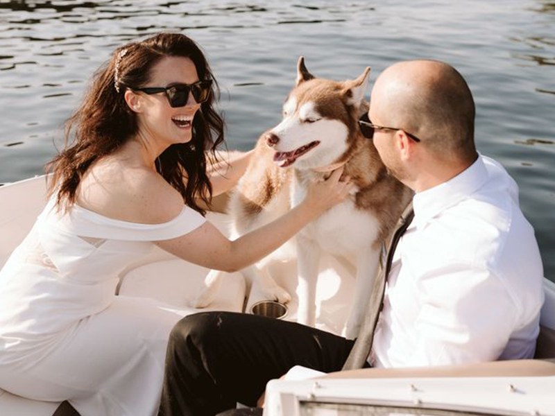 Nick and Brittany on the water with Willow the husky