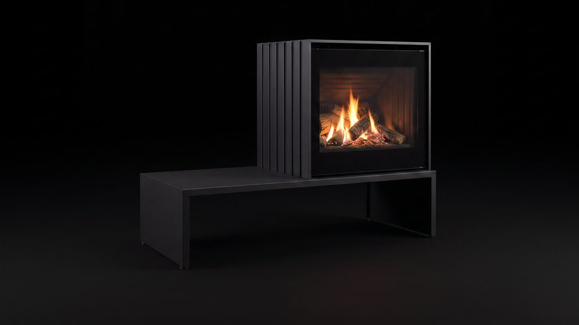 The Enviro Cube — freestanding gas stove — burning in the black studio void