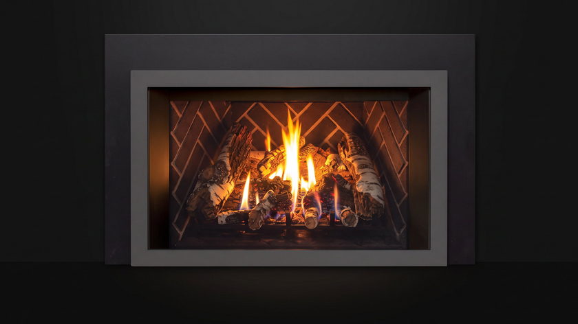The Enviro E33 — gas fireplace insert — burning in the black studio void
