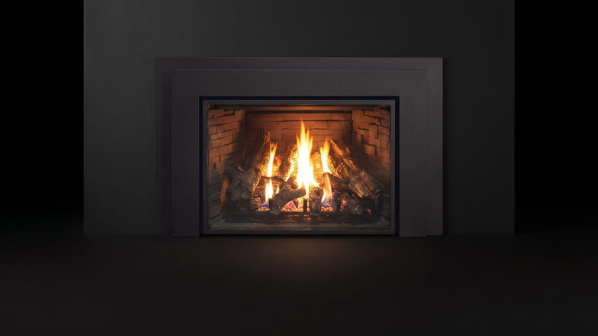 The Enviro E44 — gas fireplace insert — burning in the black studio void