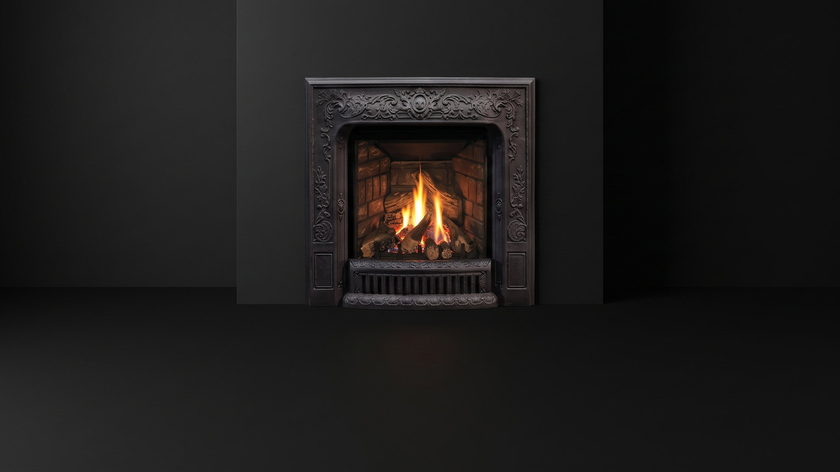 The Enviro Q1 — gas fireplace insert — burning in the black studio void