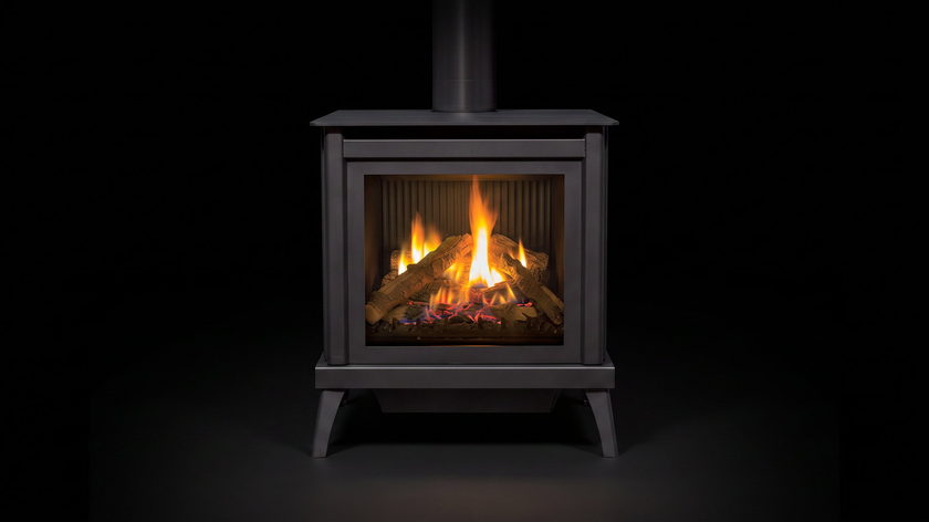 The Enviro S40 — freestanding gas stove — burning in the black studio void