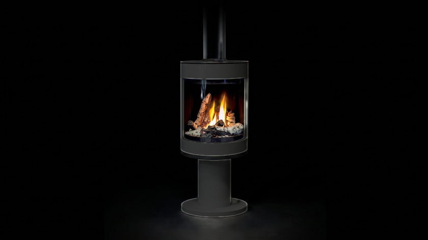 The Enviro S50 — freestanding gas stove — burning in the black studio void