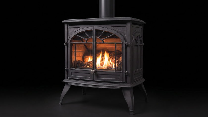 The Enviro Westport — cast iron gas stove — burning in the black studio void