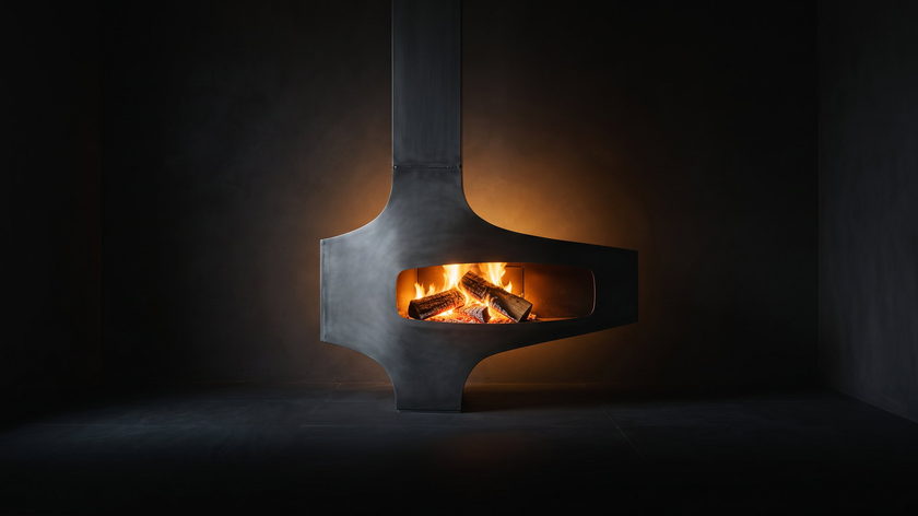 The Heterofocus — suspended wood fireplace — burning in the black studio void