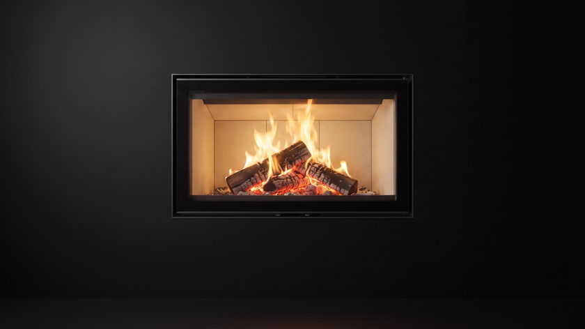 The Stûv 16-Z — zero-clearance wood fireplace — burning in the black studio void