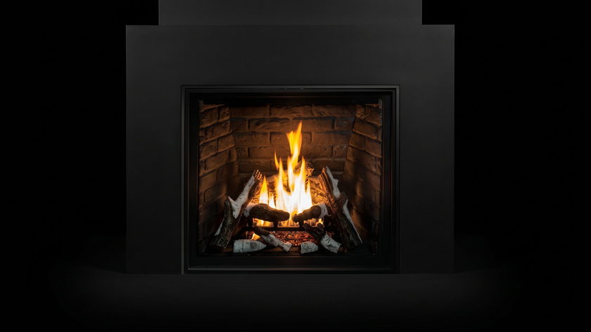 The Urbana U37 — traditional gas fireplace — burning in the black studio void