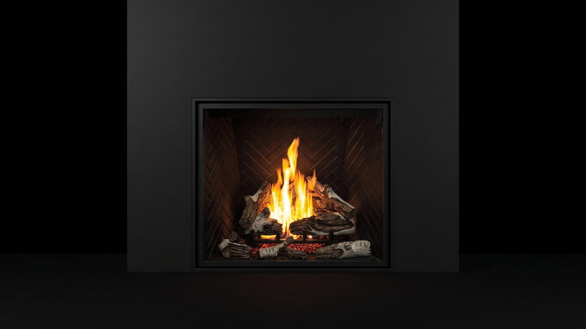 The Urbana U44 — traditional gas fireplace — burning in the black studio void
