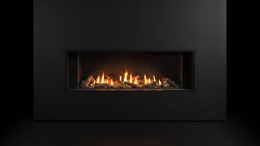 The Urbana U50 Linear — gas fireplace — burning in the black studio void