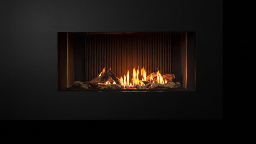 The Urbana U50 Tall Linear — gas fireplace — burning in the black studio void