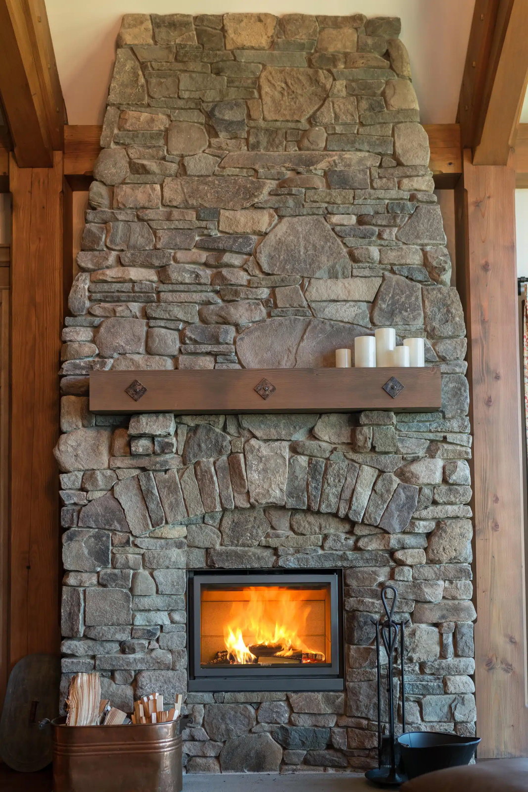 The Stûv 16-in set low in a great fieldstone chimney under timber framing