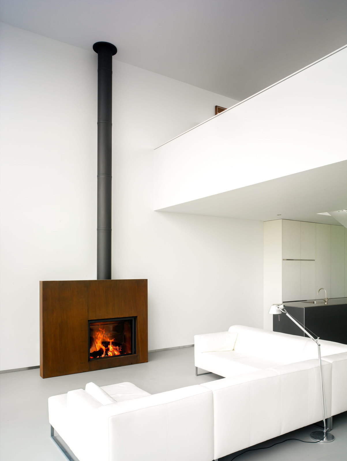 The Stûv 21-clad in its living Rust finish, standing free in a white loft