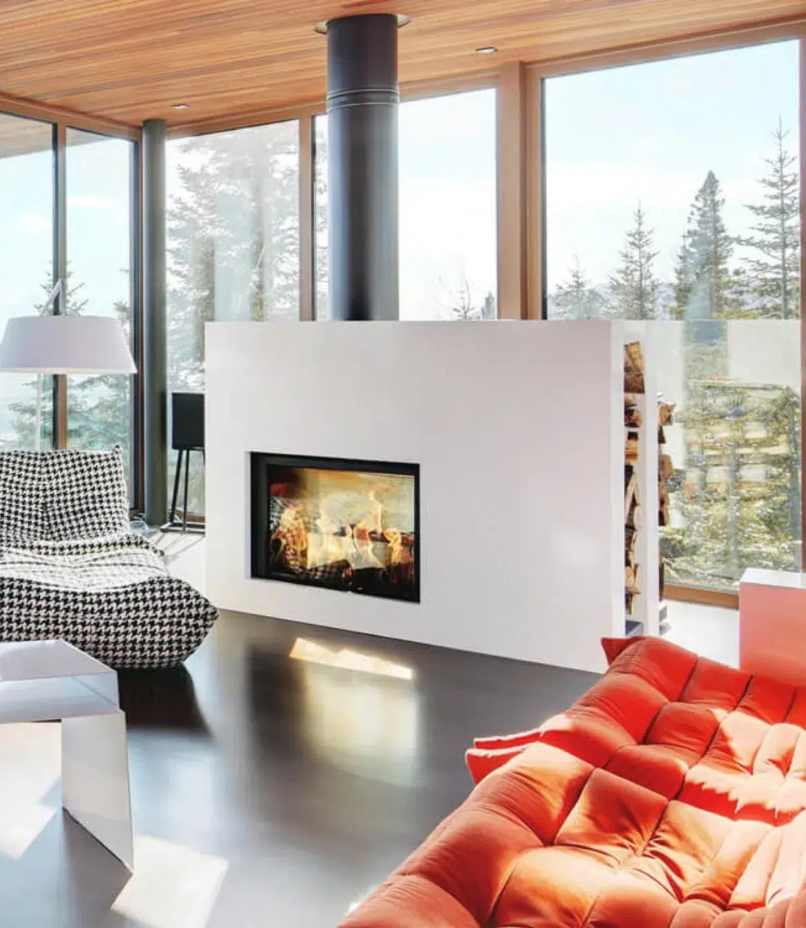The Stûv 21-clad double-face dividing a forest-view living room