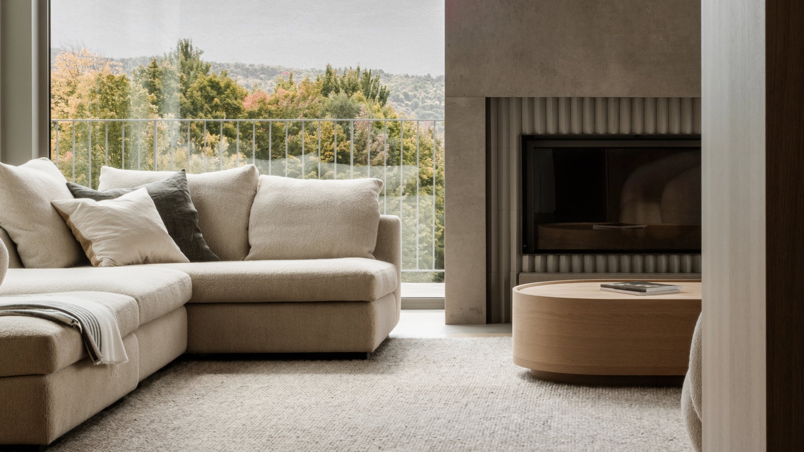 Stûv 21 set black into a concrete chimney, autumn valley beyond the glass