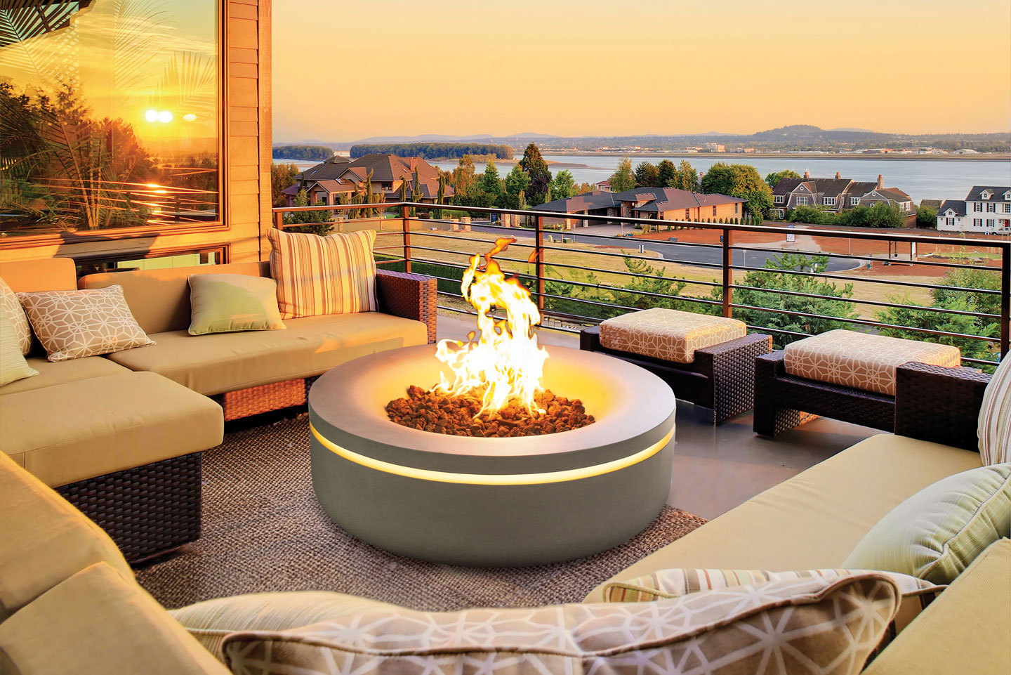 Halo concrete gas fire pit glowing on a rooftop deck at sunset