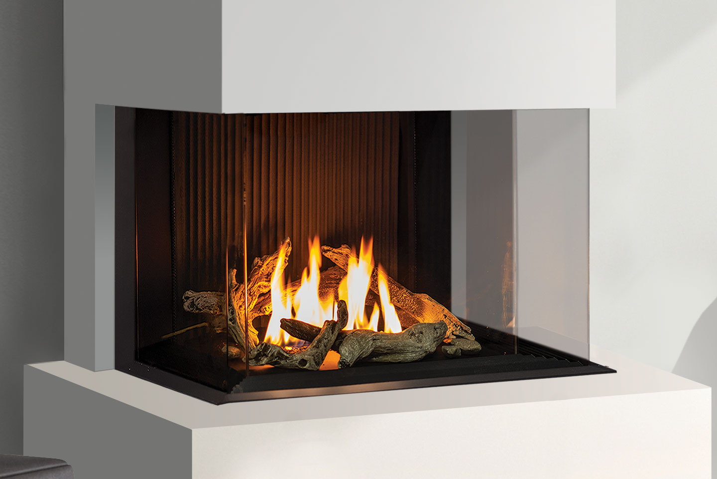 Urbana U30 Bay corner gas fireplace with driftwood logs in a white surround