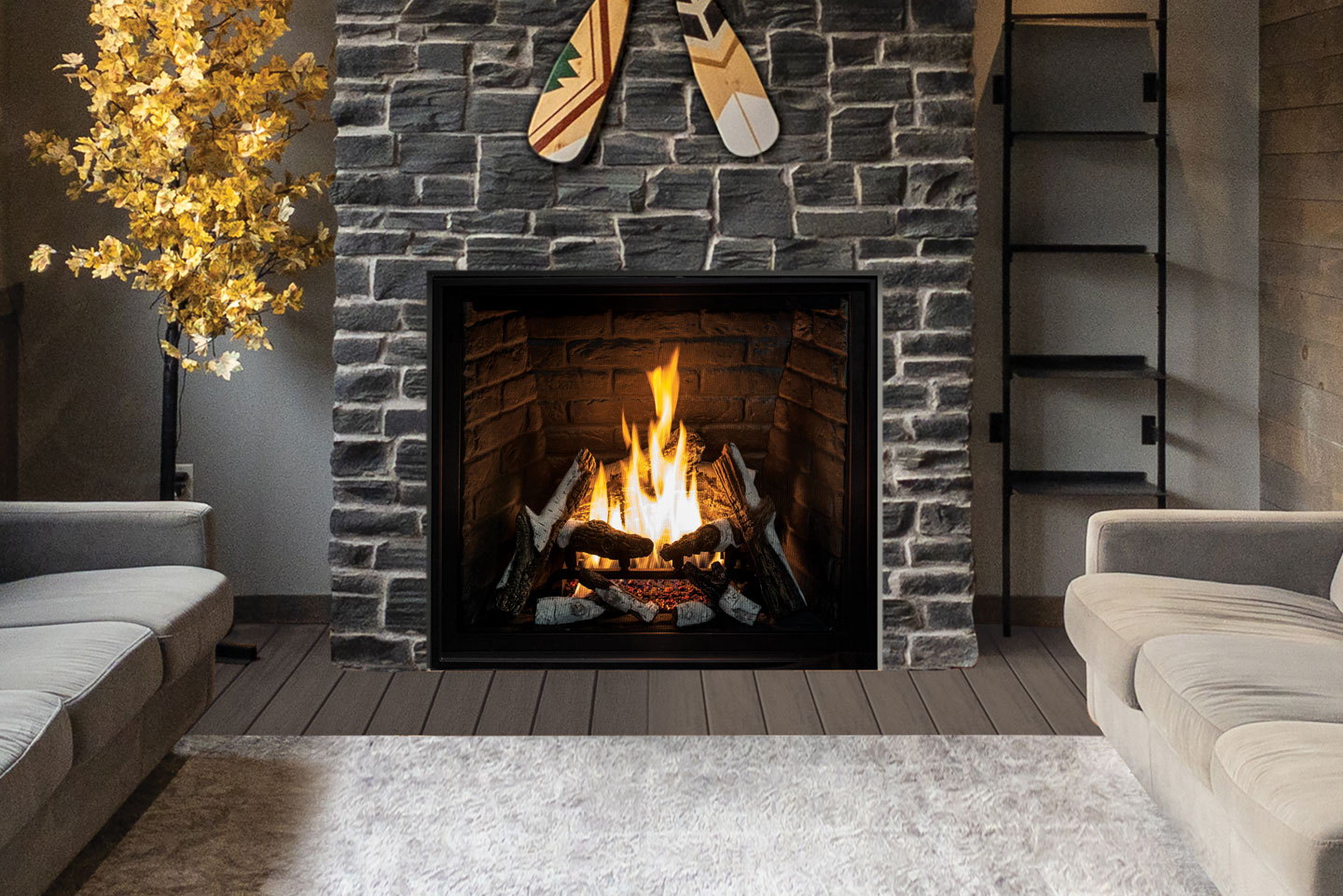 Urbana U37 gas fireplace set into a grey stone wall between paddles and dried branches
