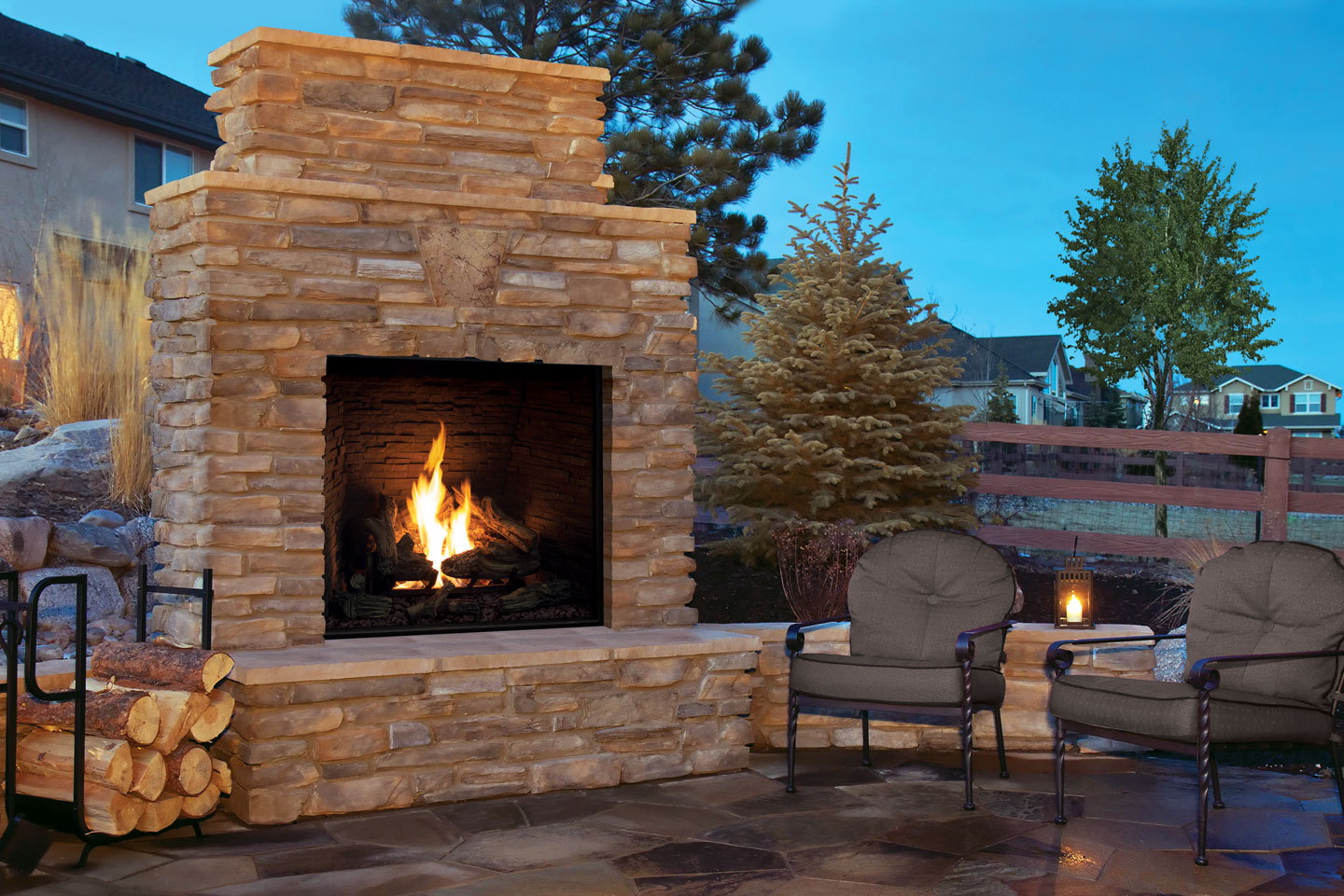 Urbana U44 Outdoor in a stacked stone surround on a backyard patio at dusk