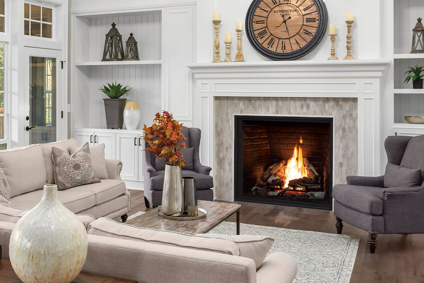 Urbana U44 traditional gas fireplace under a white mantel with a wall clock and armchairs