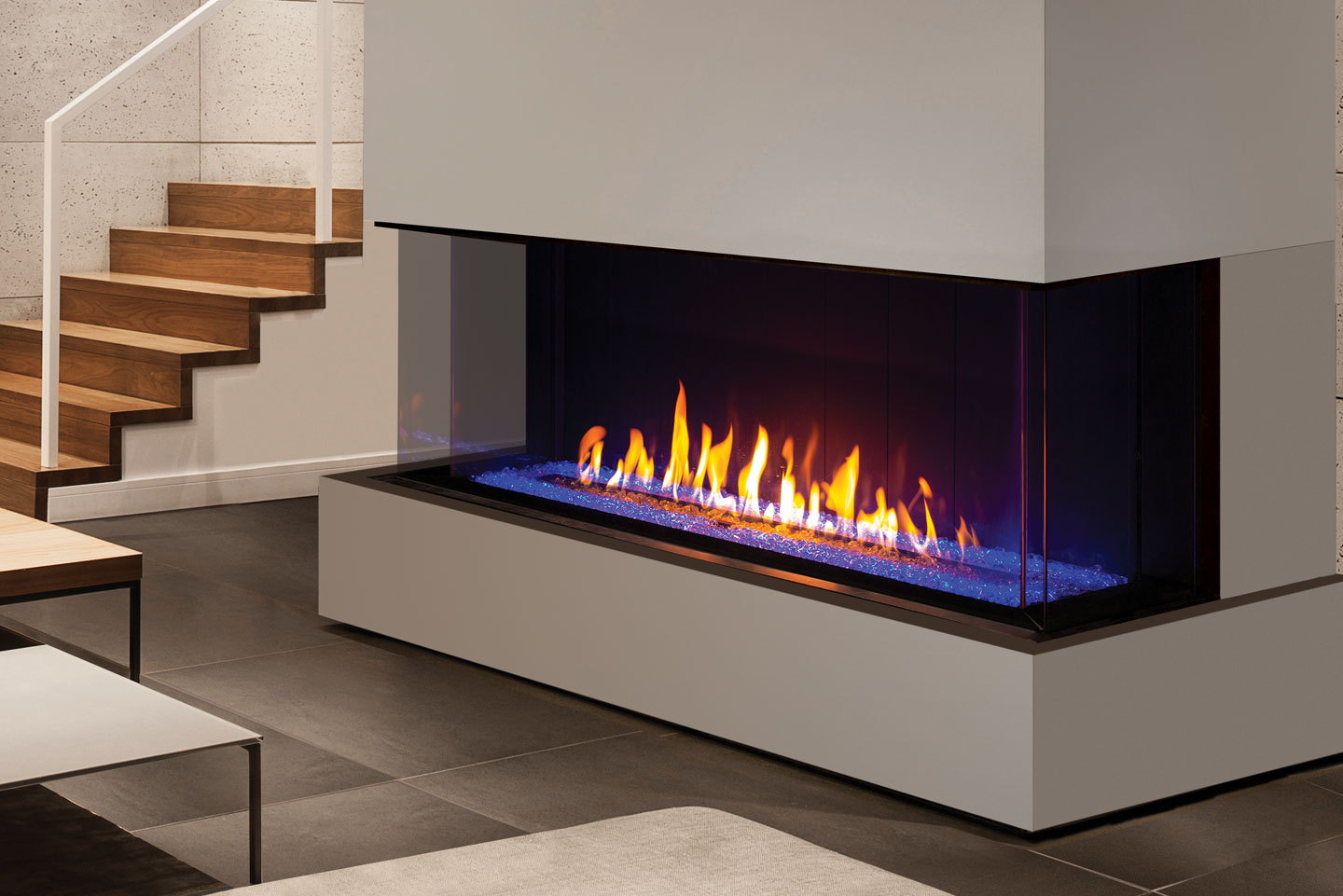 Urbana U70 Tall Bay with blue glass media on a white plinth beside stairs